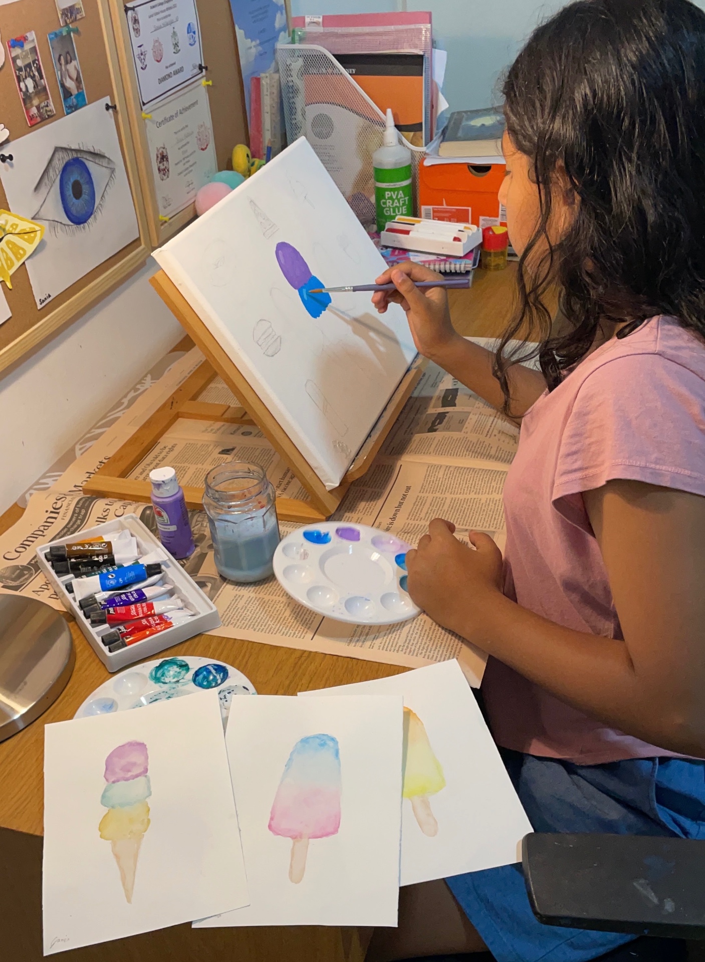 Sania painting watercolor popsicles at her easel