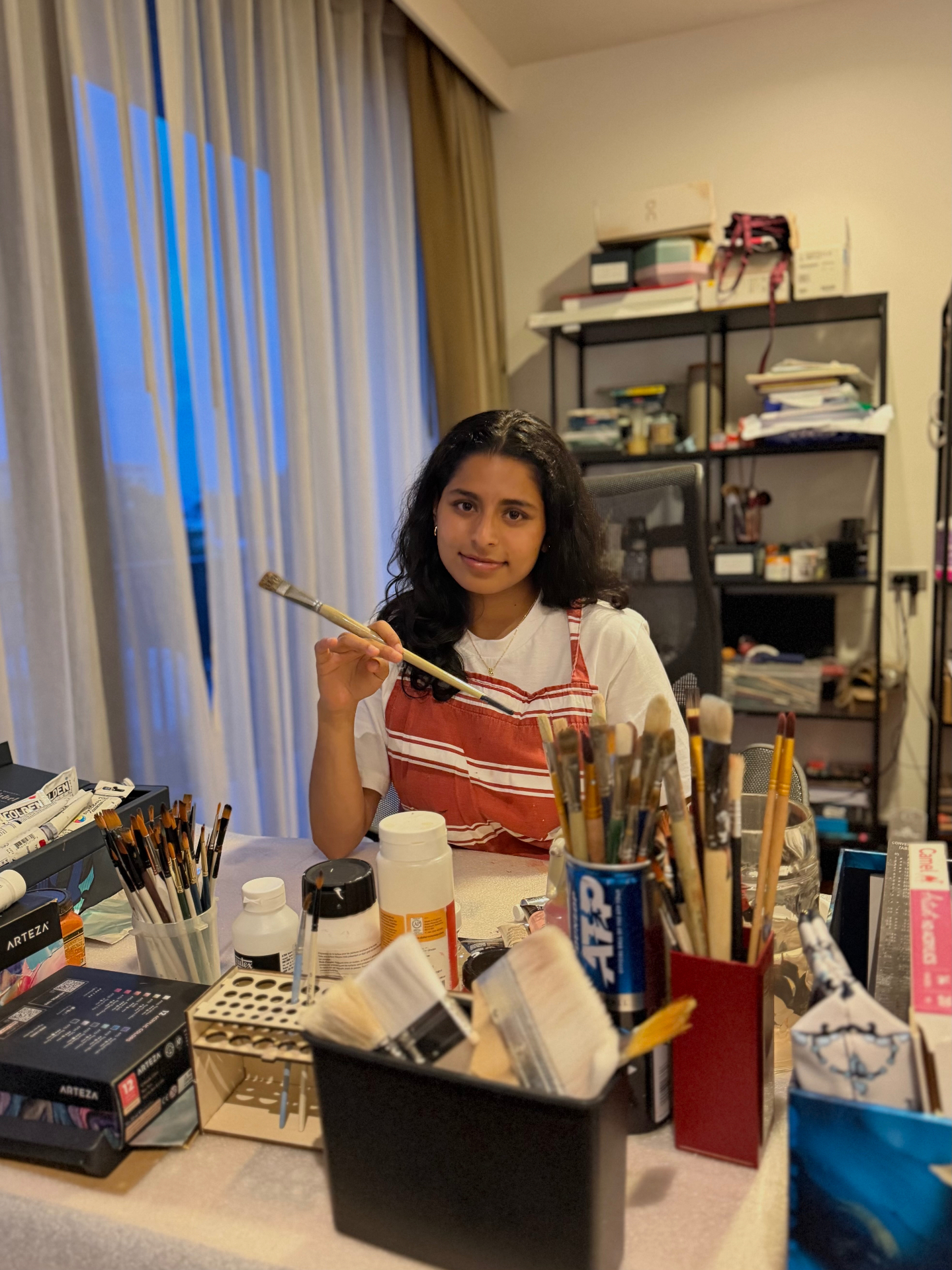 Sania in her Bay Area studio surrounded by brushes and paints