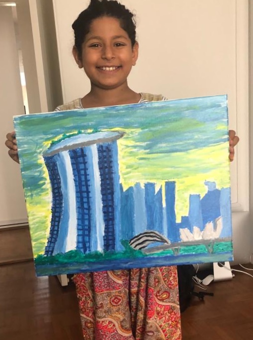 Sania proudly holding her finished Marina Bay Sands painting