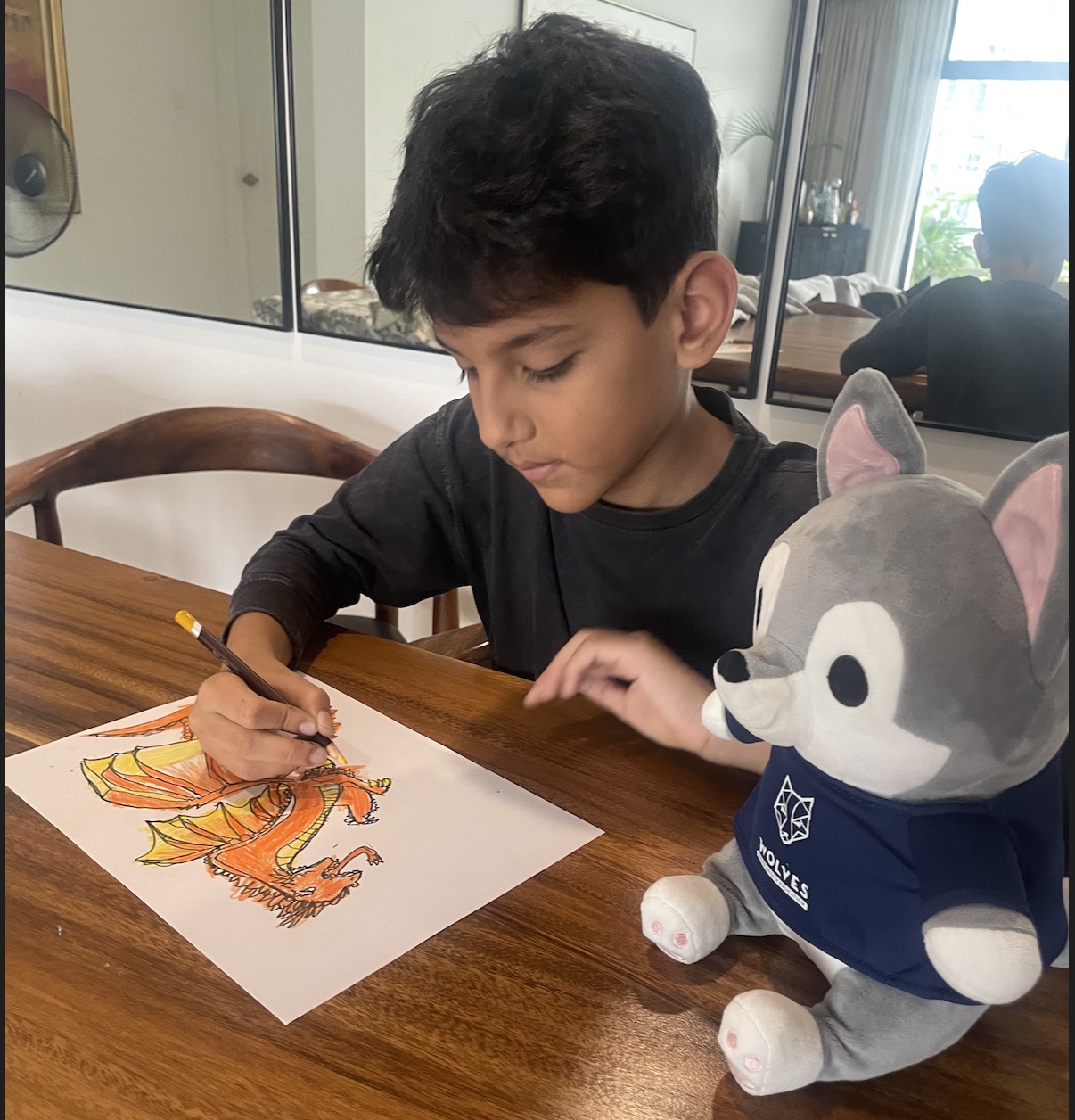 Young student sketching a dragon in marker